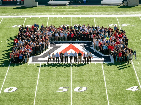 Image of entire Facilities Management staff on football field